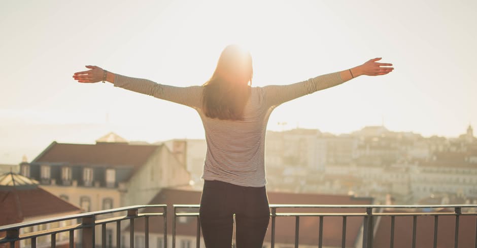 Woman Stretching Her Arms While Facing The Sun